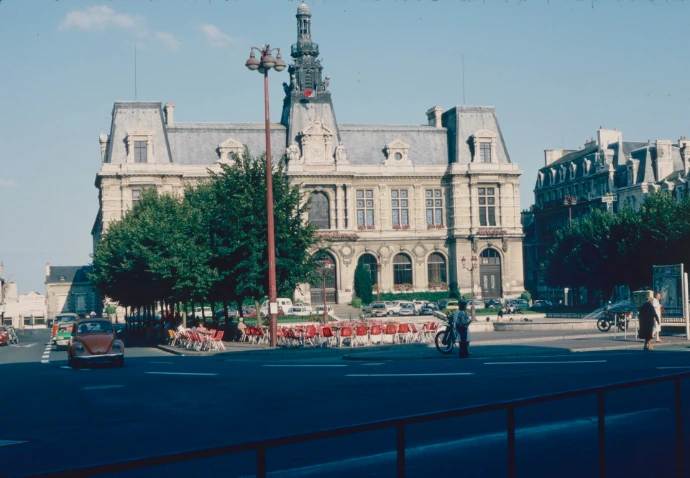 a large building with a street and cars in front of it